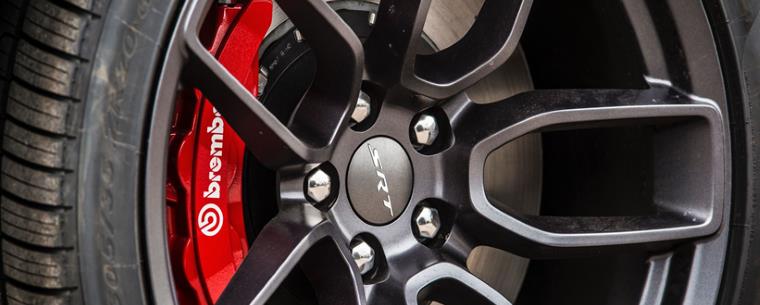 car tyre with the brake rotor on the inside and red brake calipers