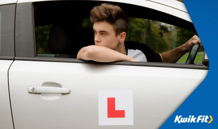 Young learner reversing in his car.