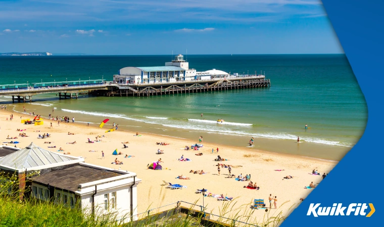 Bournemouth beach on a sunny day with clear blue skies.