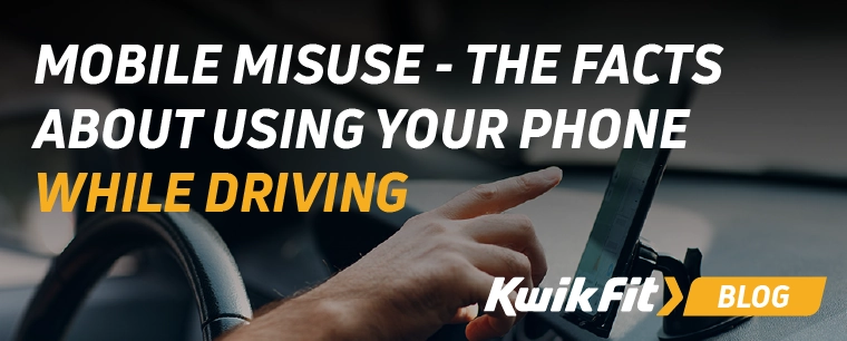 Person pressing phone screen whilst driving.